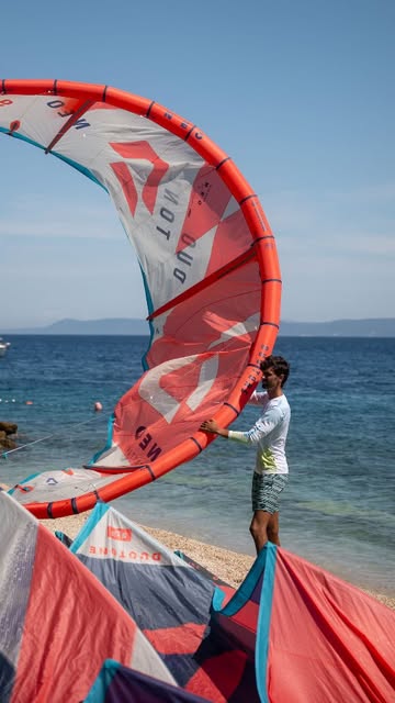 An instructor handling a red Duotone kite
