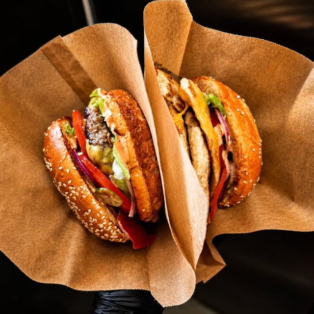 Two burgers packed for takeaway