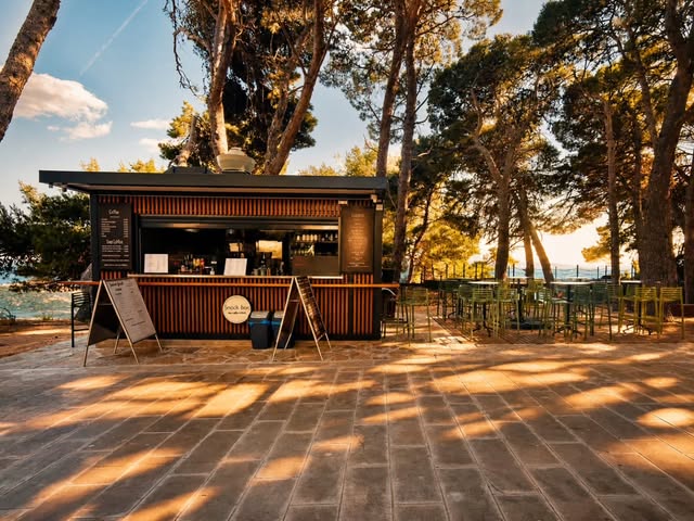 Snack Box Bol on the promenade beneath the pine trees